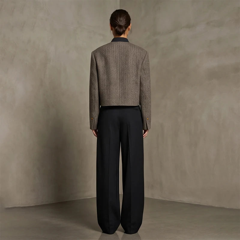 Grey herringbone cropped jacket, back view on a model