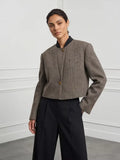Grey herringbone cropped jacket, front view on a model
