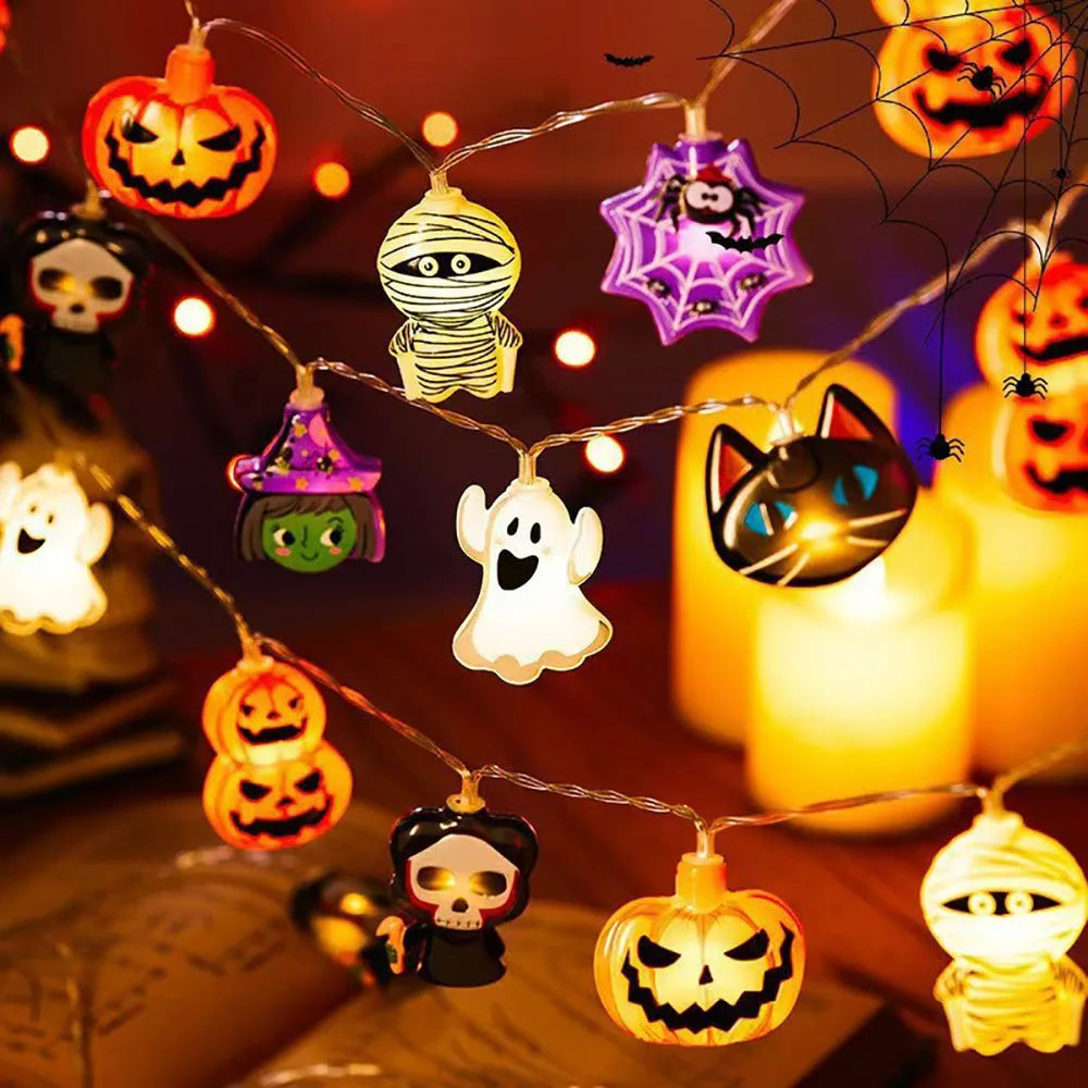 Halloween LED string lights with pumpkin, ghost and spiderweb shapes glowing in warm orange light