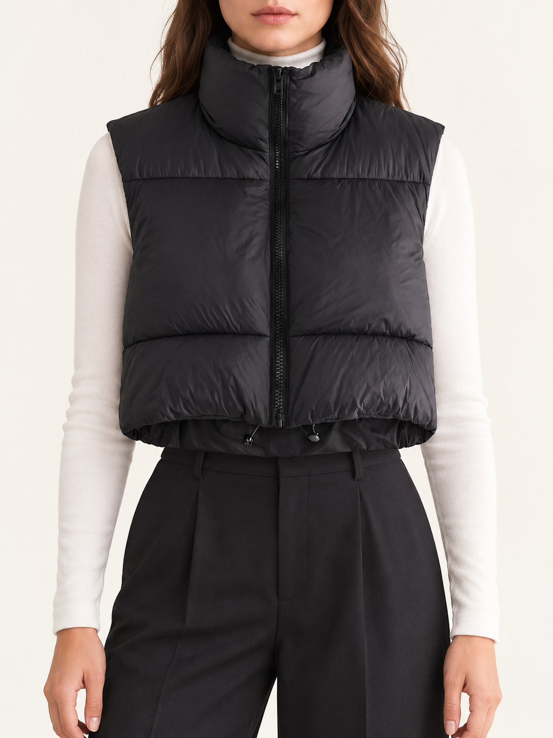Black cropped quilted vest, front view on a model