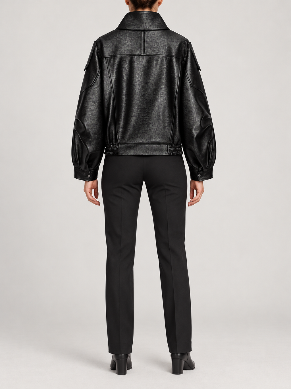 black leather-look cropped biker jacket with high fold collar and asymmetric front, back view on a model