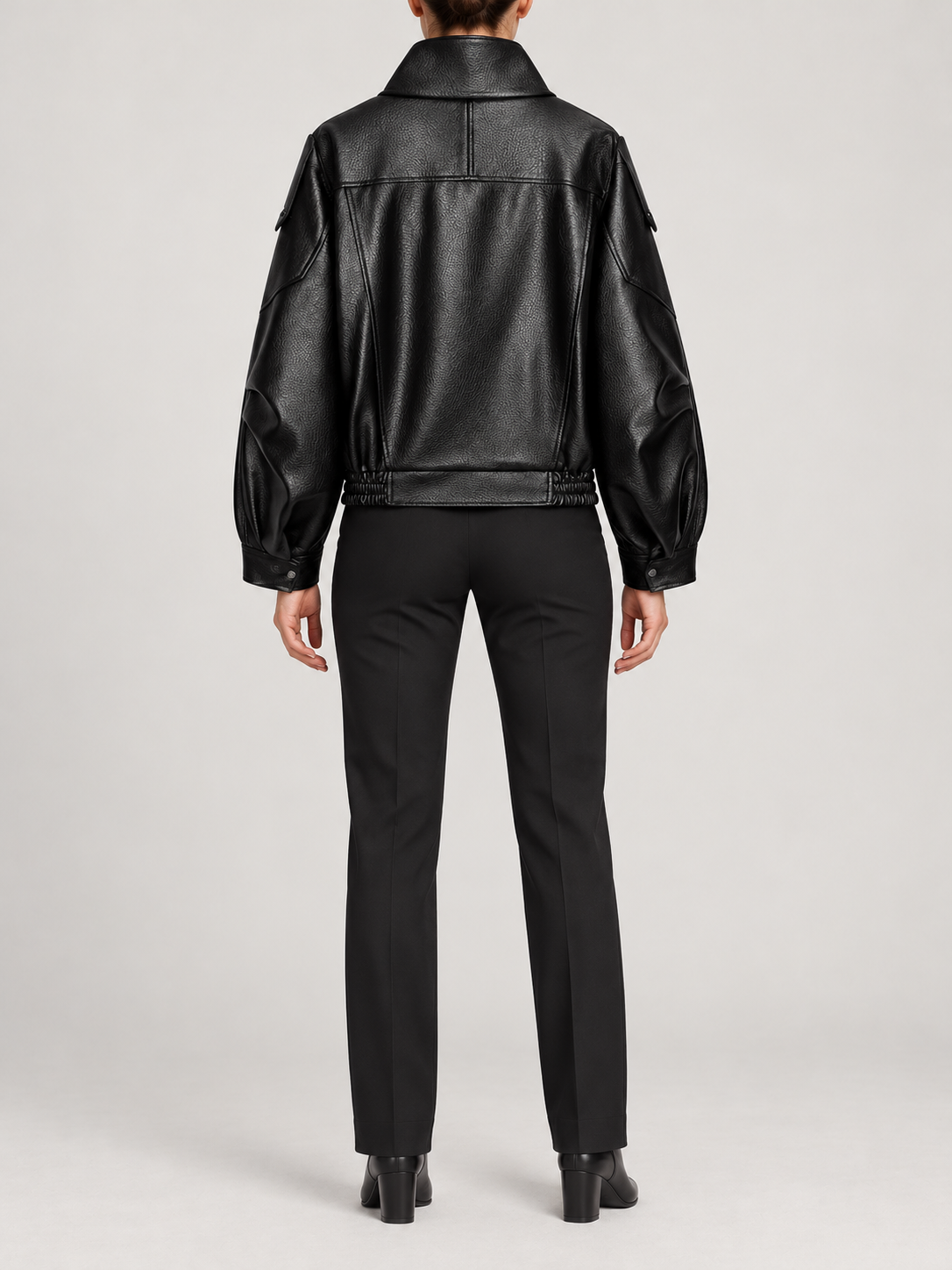black leather-look cropped biker jacket with high fold collar and asymmetric front, back view on a model
