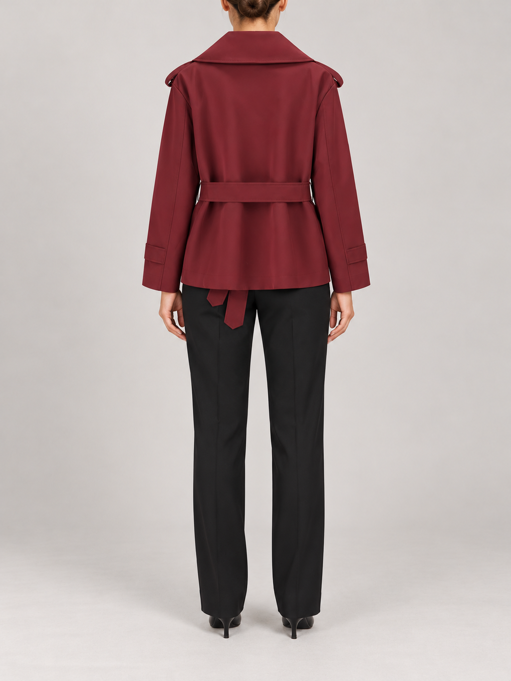 burgundy short double-breasted trench, wide lapels, shoulder tabs, waist tie, cuff tabs, back view on a model