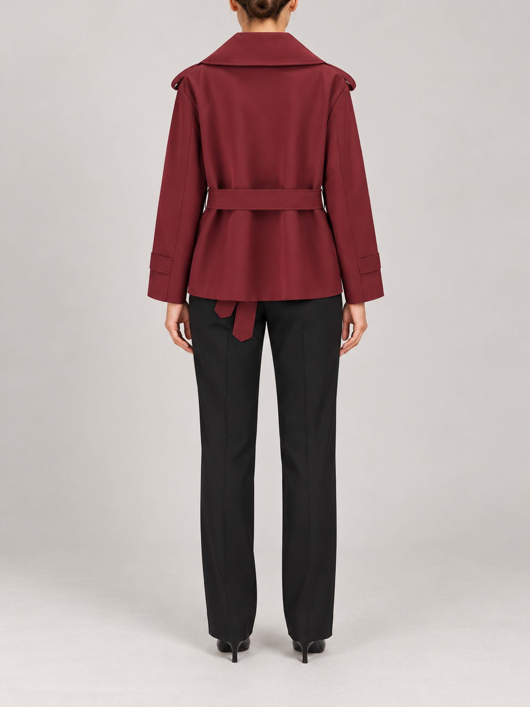 burgundy short double-breasted trench, wide lapels, shoulder tabs, waist tie, cuff tabs, back view on a model