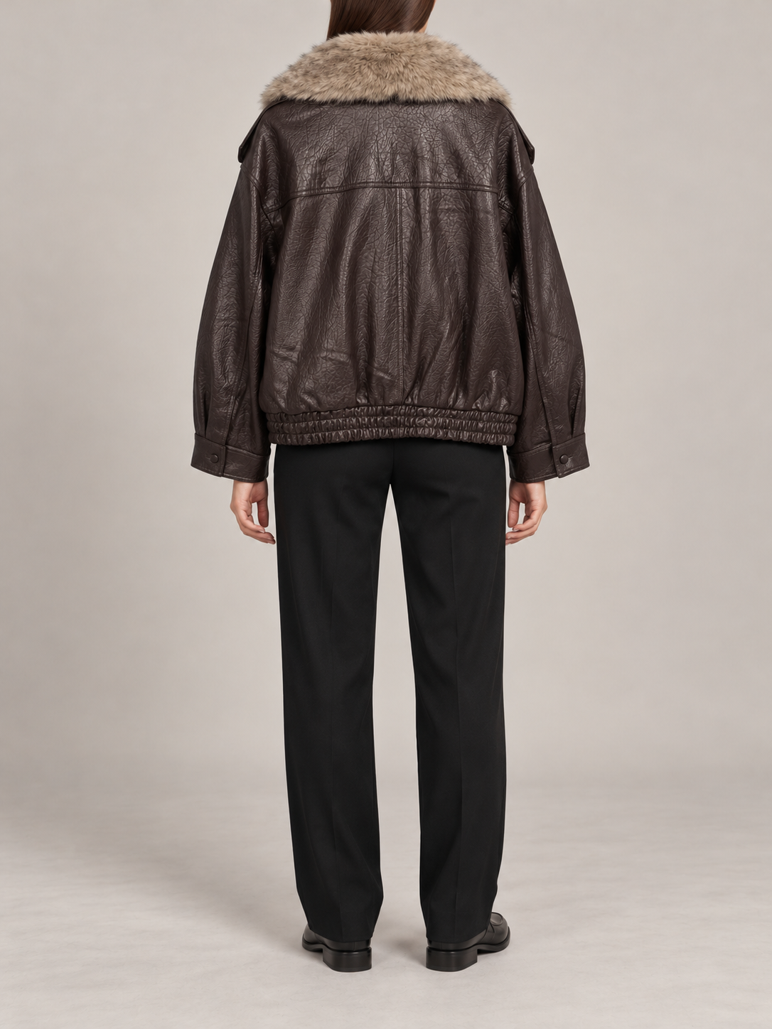 dark brown leather-look short jacket, back view on a model