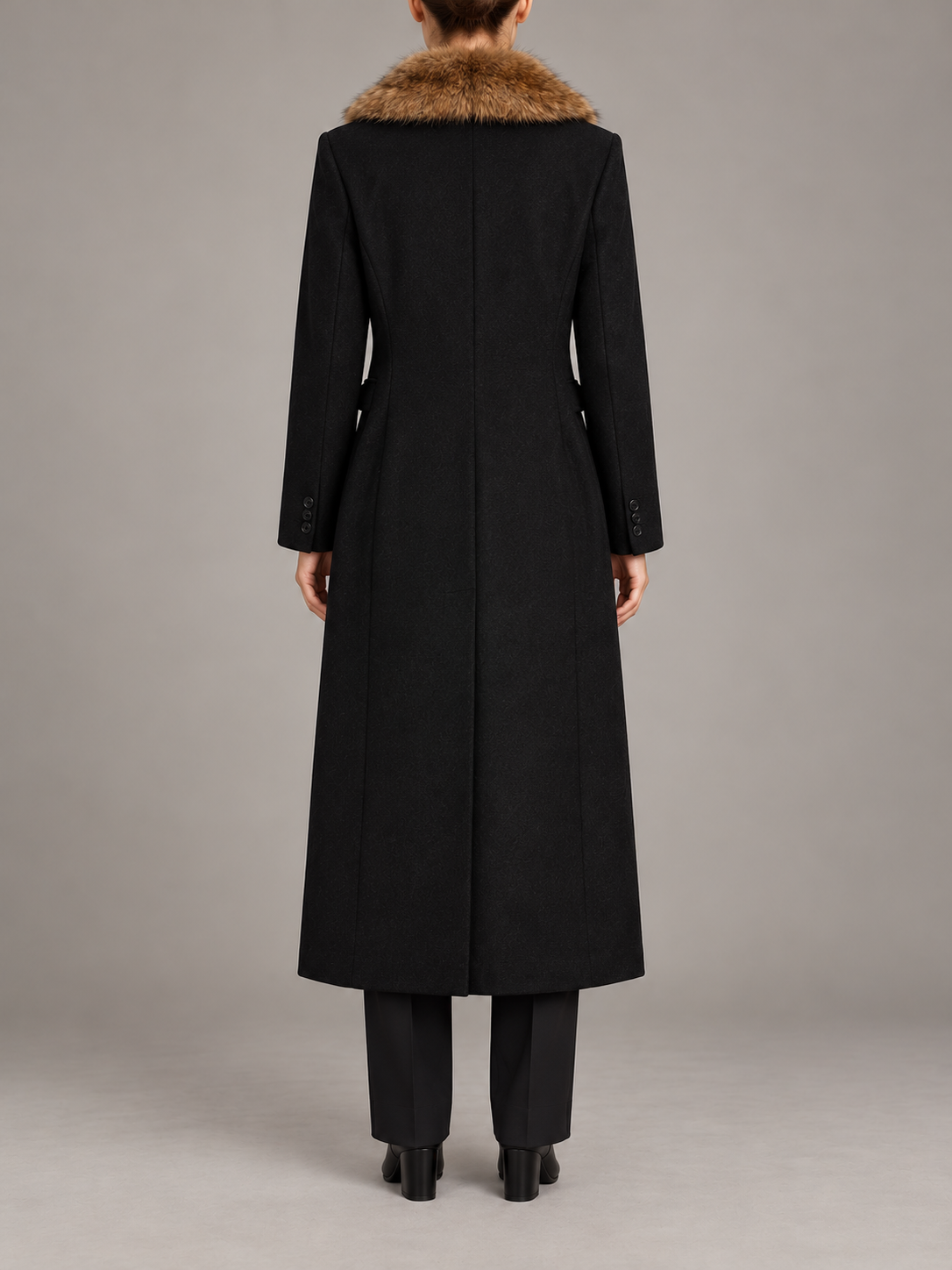 black long tailored coat with brown faux-fur shawl collar, button front and flap pockets, back view on a model