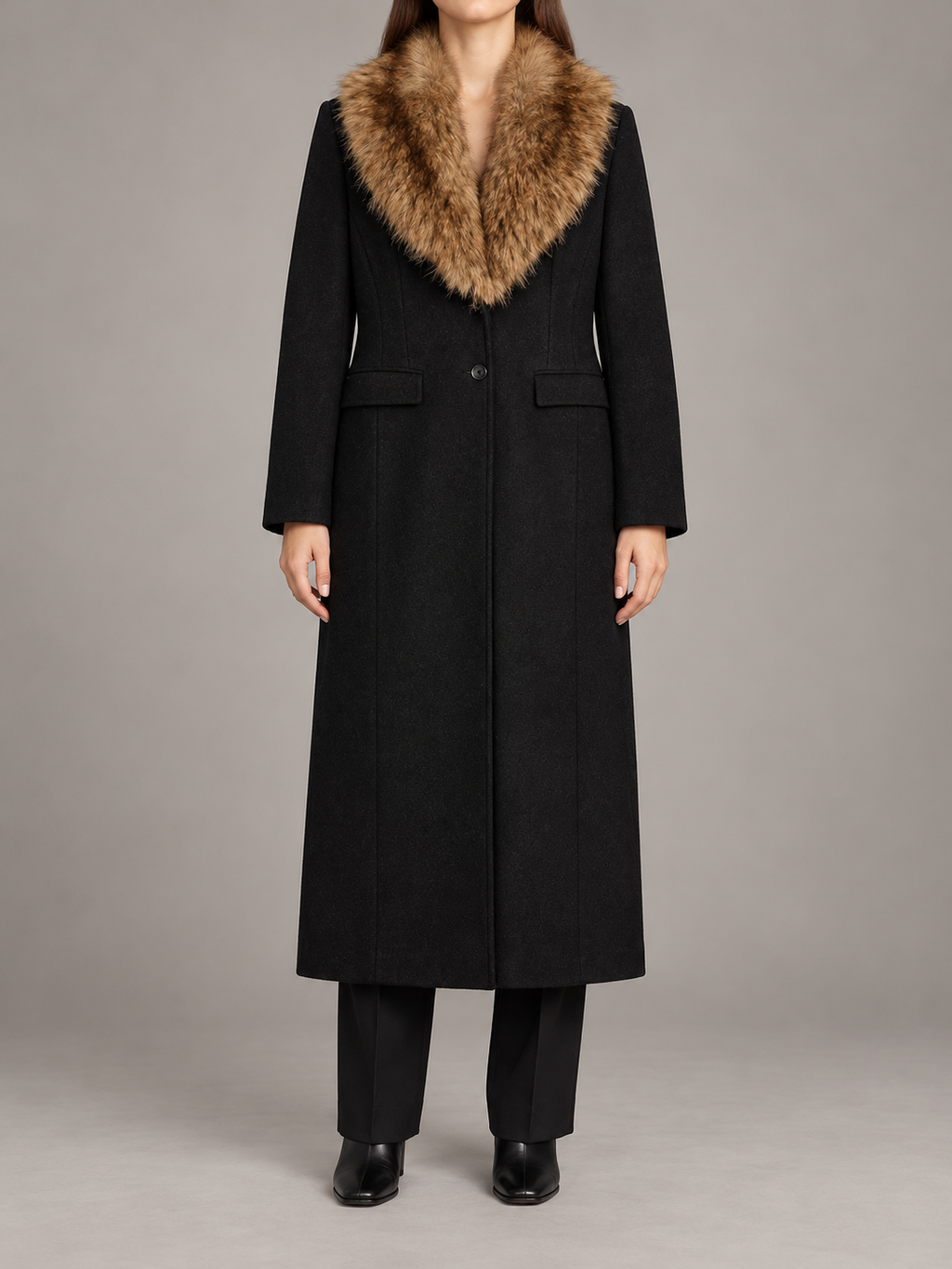 black long tailored coat with brown faux-fur shawl collar, button front and flap pockets, front view on a model