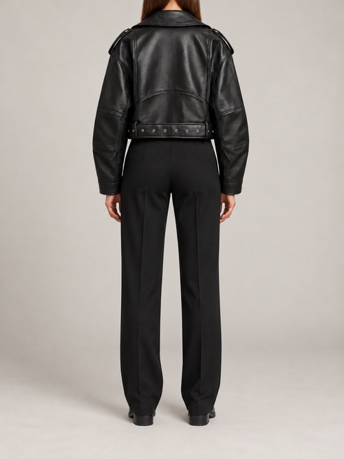 black cropped moto jacket with silver zipped pockets, back view on a model