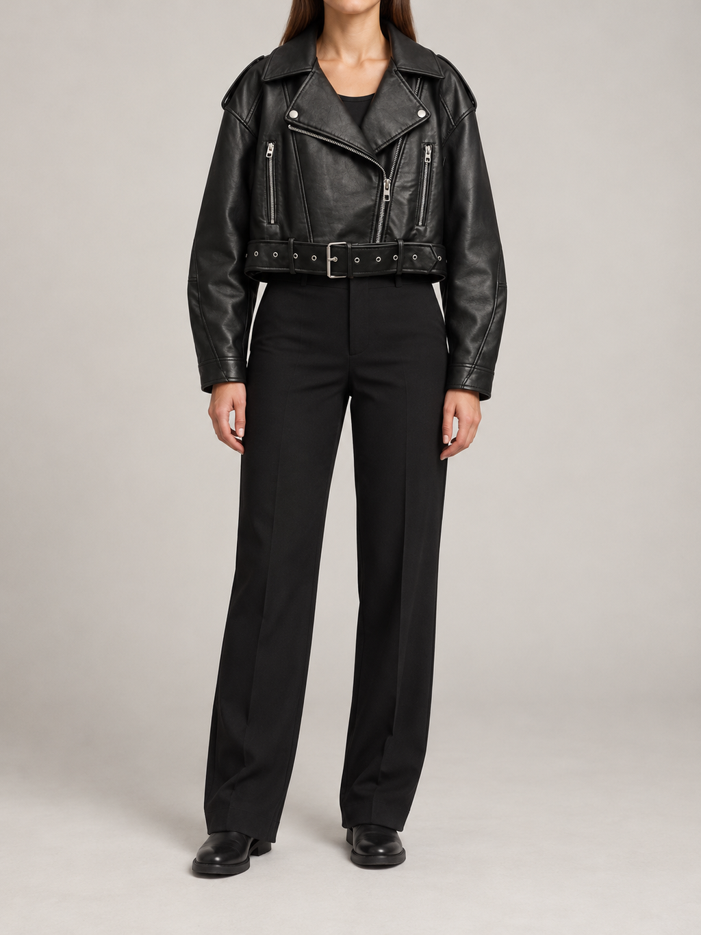 black cropped moto jacket with silver zipped pockets, front view on a model