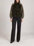 dark olive short jacket with chevron faux-fur body panels, olive knitted sleeves and ribbed cuffs, front view on a model