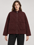 Burgundy quilted zip jacket with two patch pockets, front view
