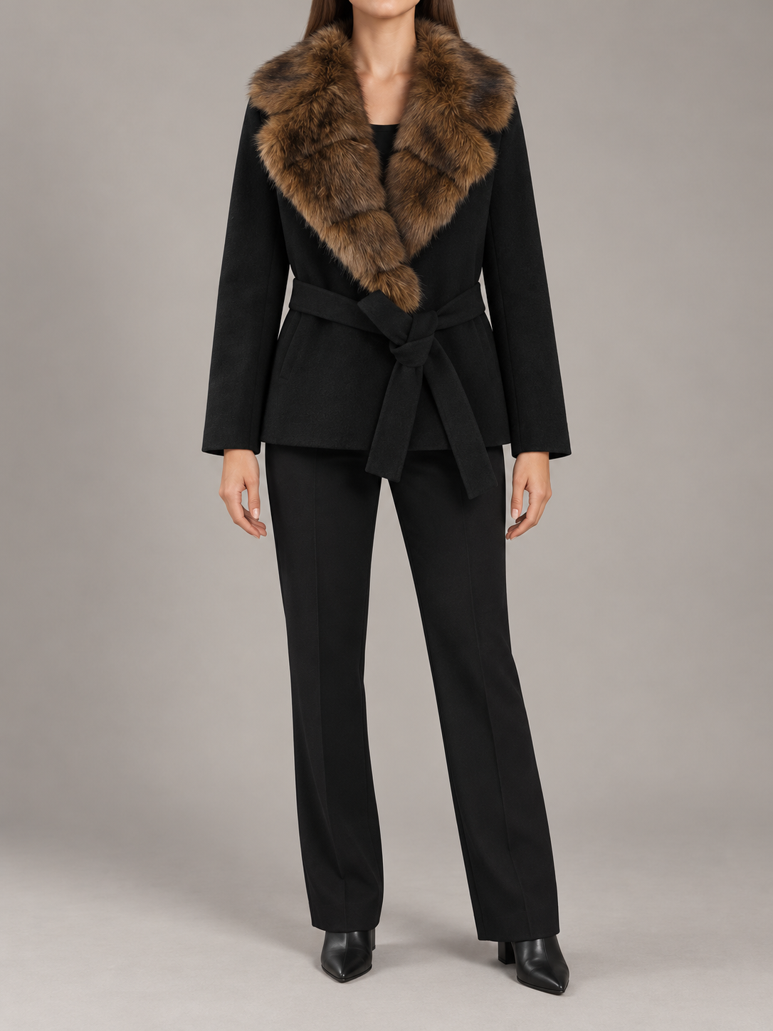black short belted coat with brown segmented faux-fur shawl collar, straight sleeves and fabric waist tie, front view on a model