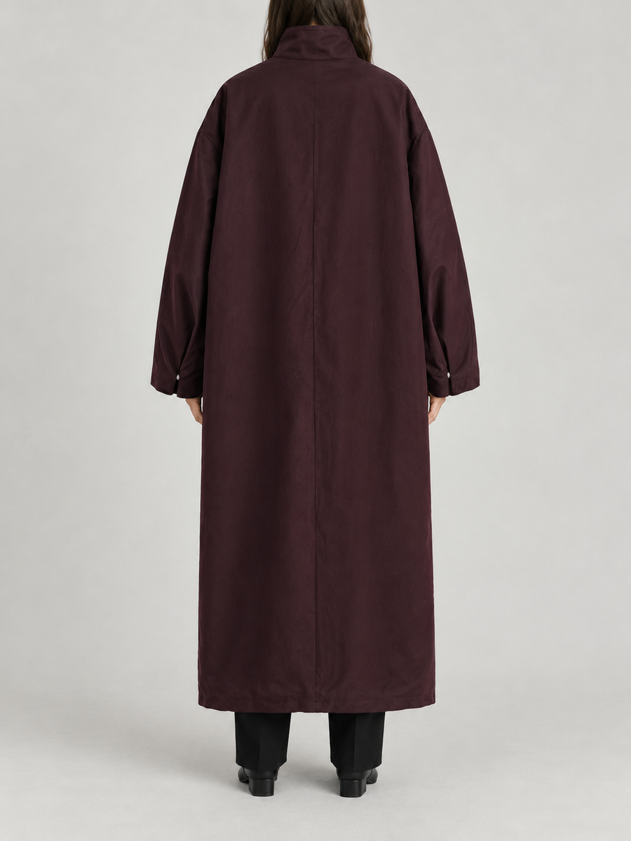dark plum oversized ankle-length high-neck trench, concealed placket and very wide dropped shoulder sleeves, back view on a model