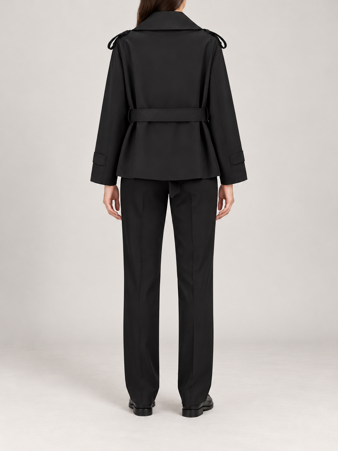 black short belted wrap trench, back view on a model